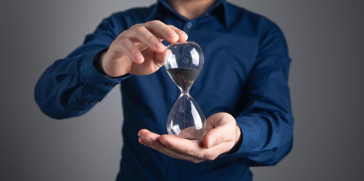 caucasian businessman showing hourglass time management 220873 66721