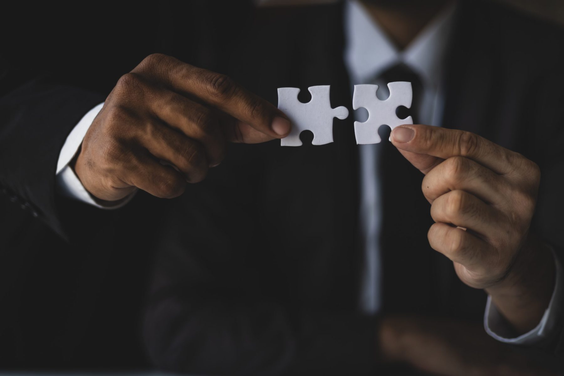 people hand holding puzzles connect teamwork people organization jigsaw scaled